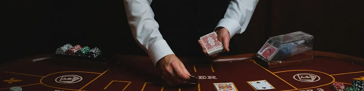 Casino dealer dealing cards on a blackjack table
