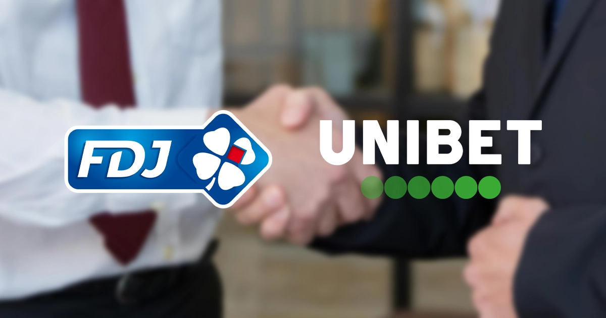 Twee mannen schudden elkaar de hand op de achtergrond met de logo's van fdj en unibet