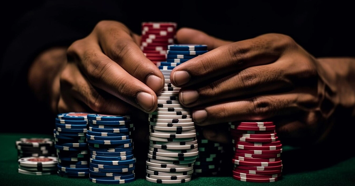 Hands surrounding casino chips on black background