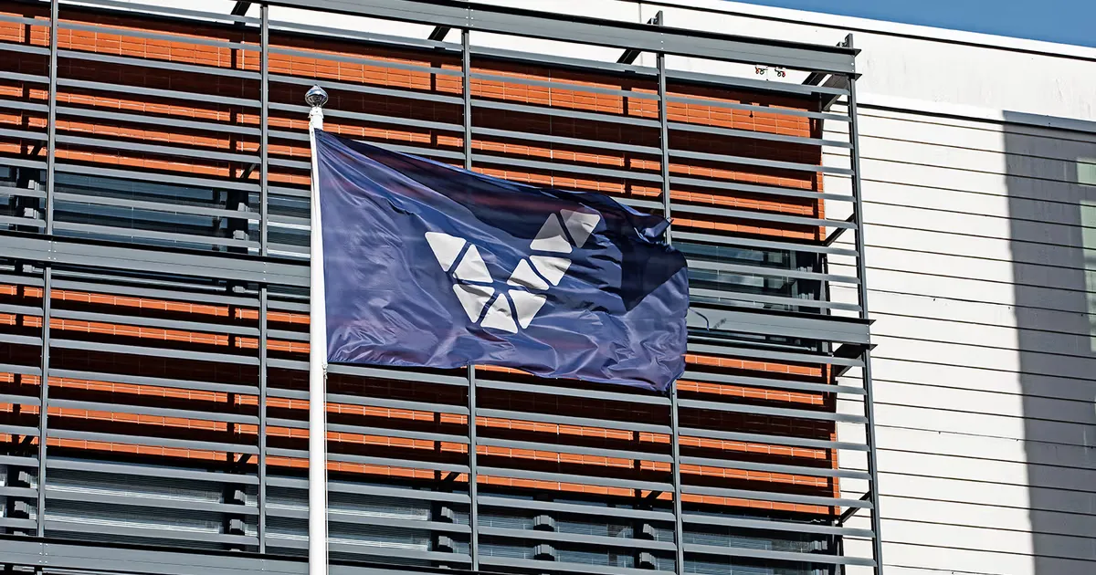 Flag with the veikkaus logo on a building belonging to the company.